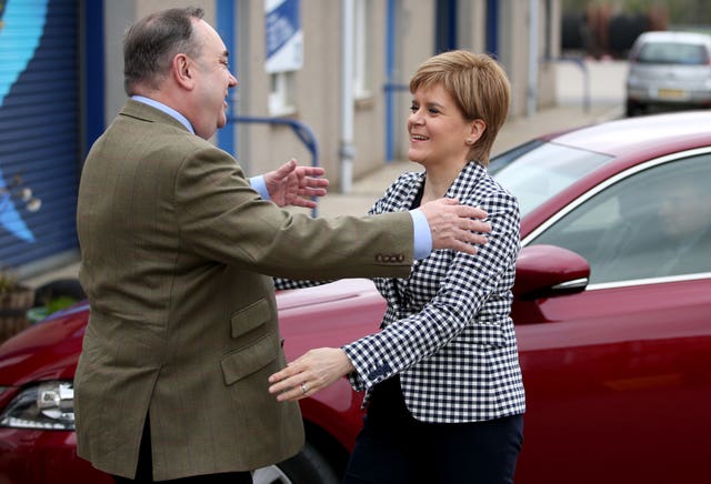 Alex Salmond and Nicola Sturgeon with their arms open wide about to embrace each other in a hug back in 2017