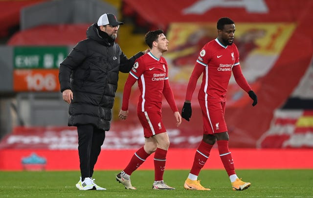 Liverpool manager Jurgen Klopp consoles Andrew Robertson and Divock Origi