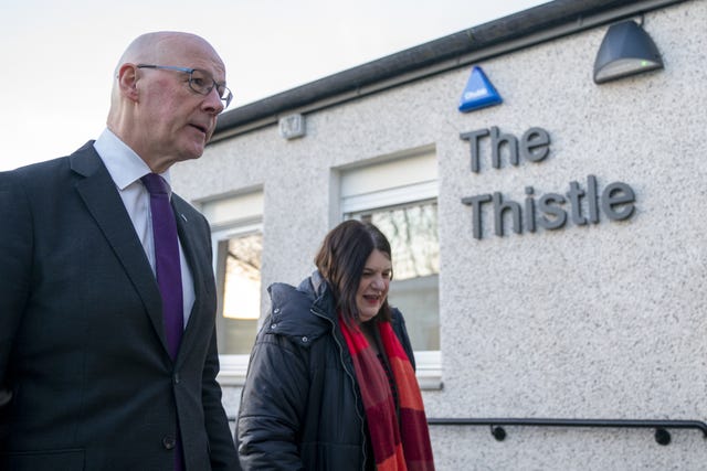 John Swinney and Susan Aitken outside a building with the sign 'The Thistle' on it