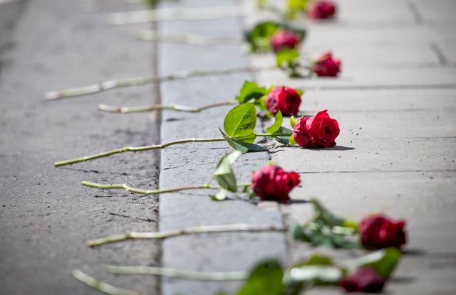 Roses placed on the street for the funeral cortege of Xander Irvine