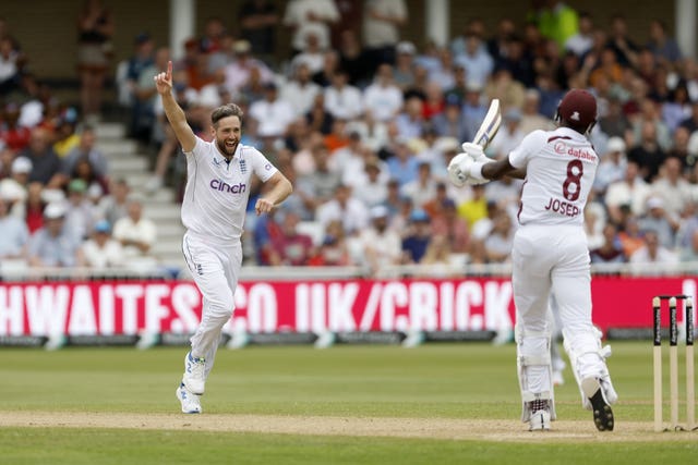 England’s Chris Woakes, left, celebrates taking the wicket of the West Indies’ Alzarri Joseph, right