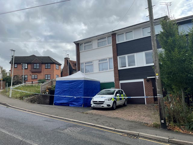 Police car and forensic tent outside the house