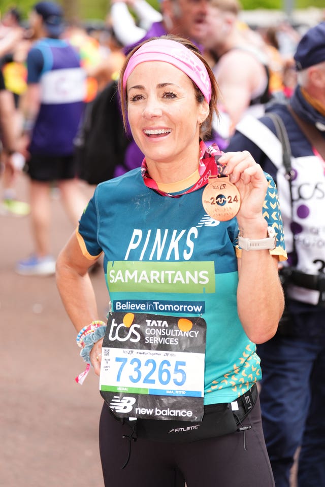 Natalie Pinkham showing off her medal after running the TCS London Marathon for Samaritans