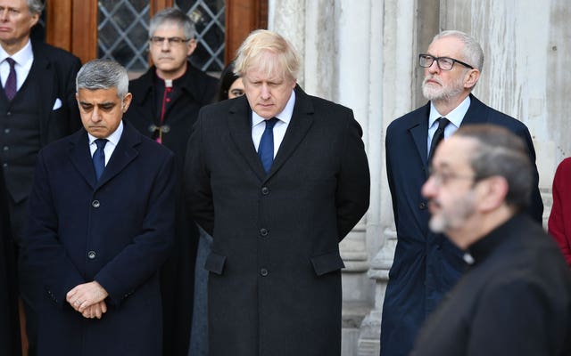 Sadiq Khan, Boris Johnson and Jeremy Corbyn stand together at a London vigil