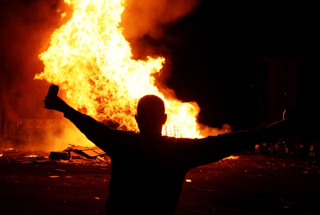 People attend a bonfire in the Sandy Row area of Belfast 