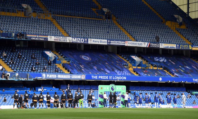 Chelsea and Wolves line up in front of empty stands at Stamford Bridge