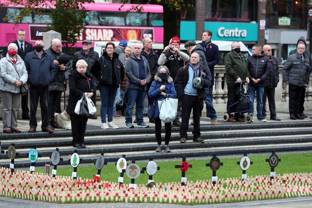 People during a two-minute silence at City Hall, Belfast, for Armistice Day