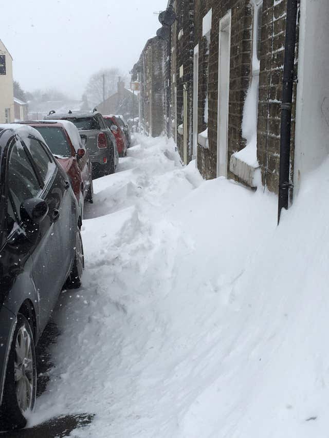 Snow drifts on Hadfield Road in Hadfield, Derbyshire (@NicosBabe/PA)