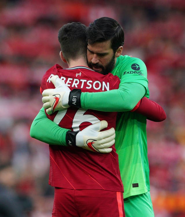 Liverpool goalkeeper Alisson Becker hugs team-mate Andy Robertson