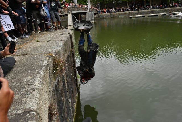 Protesters throw the statue of Edward Colston into Bristol harbour