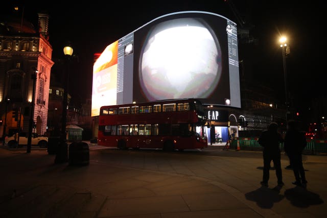 The landing being live streamed on Piccadilly Lights in central London