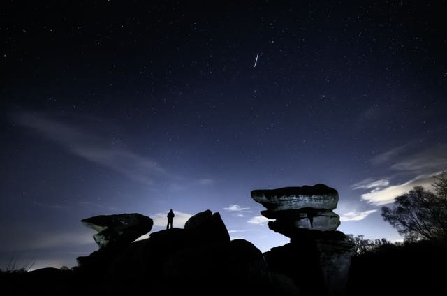 A man watches a meteor during the Geminid meteor shower