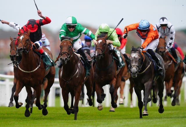 Caburn (right, orange) storming home at Newbury