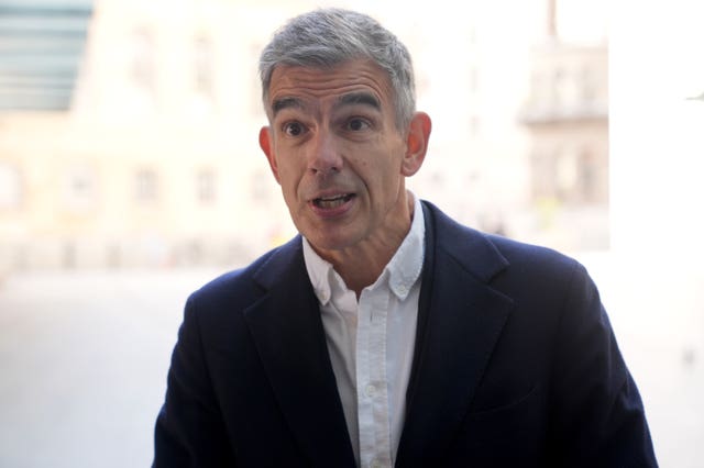 Matt Brittin speaking to cameras while wearing a white shirt and black suit jacket