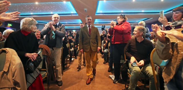 Nigel Farage is welcomed by supporters in Workington