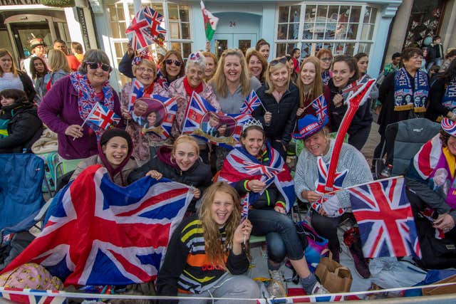 Spectators gather on the procession route (James Hardisty/PA)