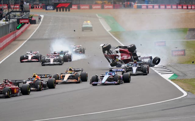 Alfa Romeo’s Zhou Guanyu, third right, flips after a collision at the start of the British Grand Prix