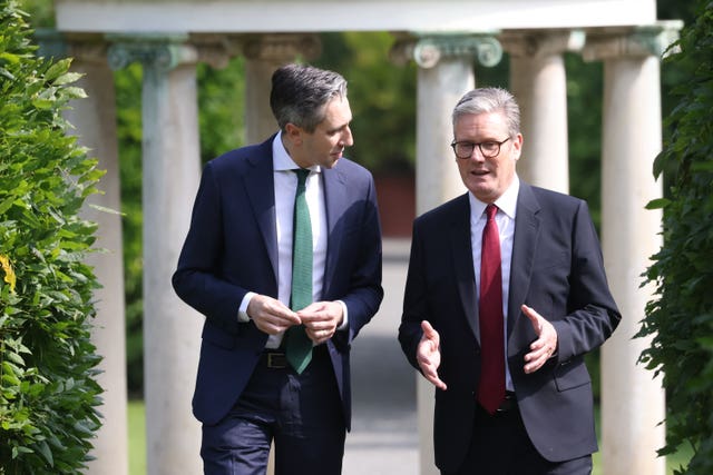 Simon Harris, left, looking at Sir Keir Starmer while Sir Keir gestures with his hands and talks