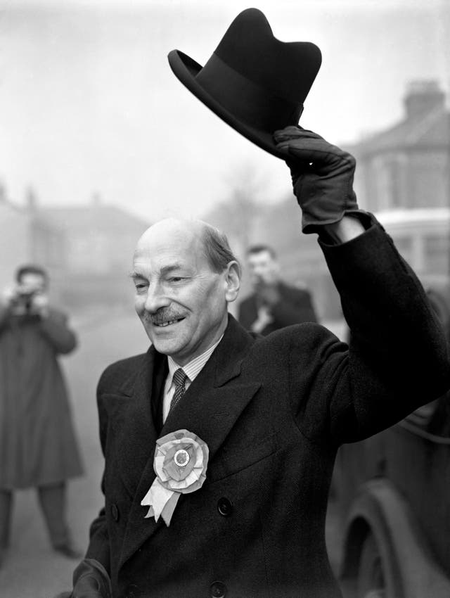 Black and white photo of Clement Attlee, smiling while raising his hat above his head