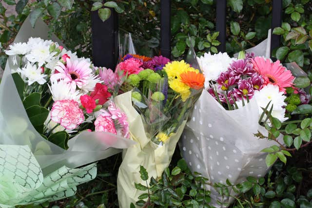 Floral tributes left outside the house in Dexter Way (Rod Minchin/PA)