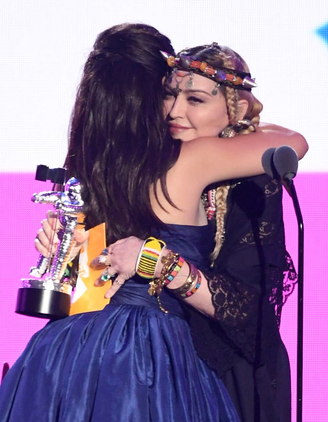 Camila Cabello (left) accepts the award for video of the year from Madonna