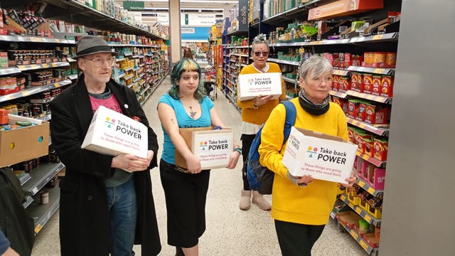 Activists in a shop with the food boxes