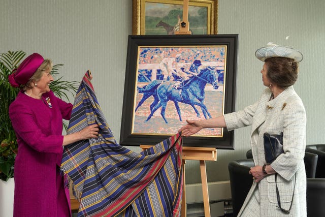 The Princess Royal receiving a gift to the Queen from Epsom Downs Racecourse presented by Julia Budd