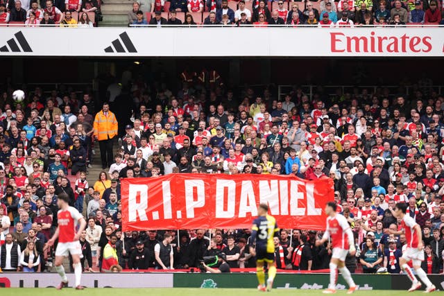 Arsenal fans hold up a banner in memory of Daniel