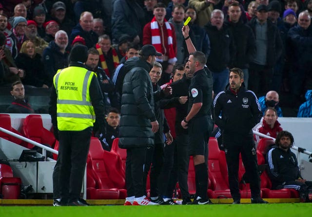 Arsenal manager Mikel Arteta and Liverpool manager Jurgen Klopp (left) receive yellow cards after exchanging words on the touchline