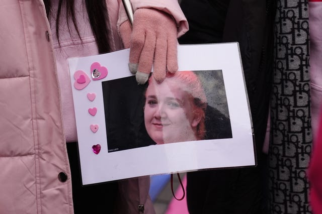 A person holding a photo of Rhiannon Whyte