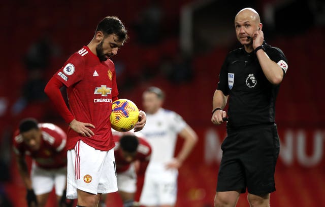 Referee Anthony Taylor in communication with his VAR colleague