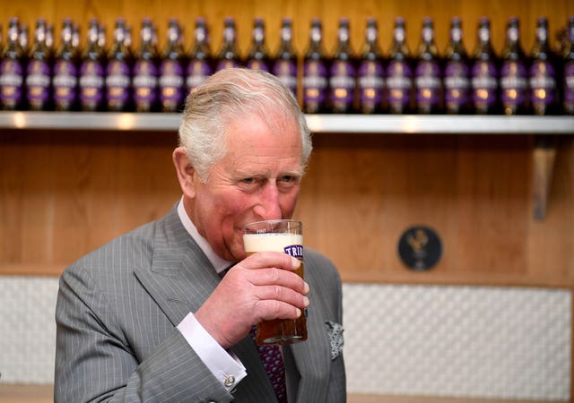 The Prince of Wales drinks from a pint of Tribute Pale Ale