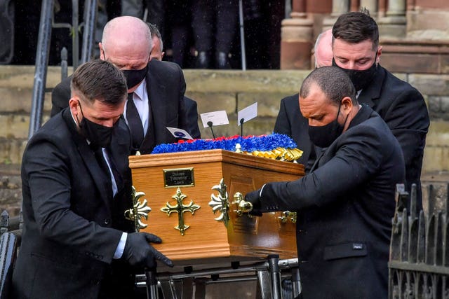 Funeral directors carry the coffin of Darren Lewis from church