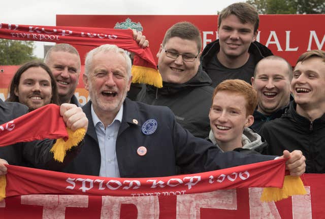 Labour leader Jeremy Corbyn poses with Liverpool fans outside Anfield 