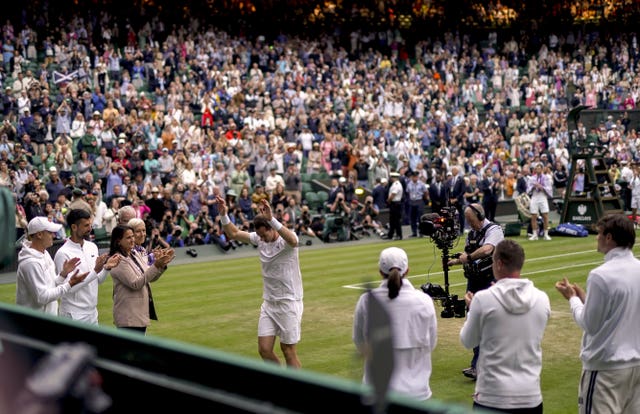 Andy Murray waves as he walks off Centre Court while being applauded by fans and players