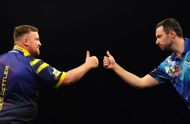 Luke Littler, left, and Luke Humphries share a fist bump