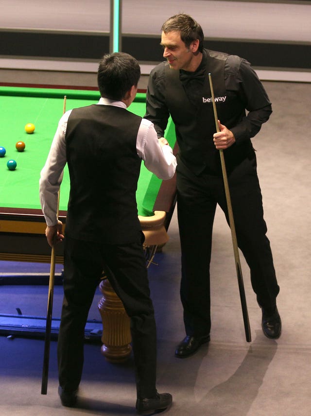 Ronnie O’Sullivan (right) and Ding Junhui shake hands after their last-16 clash