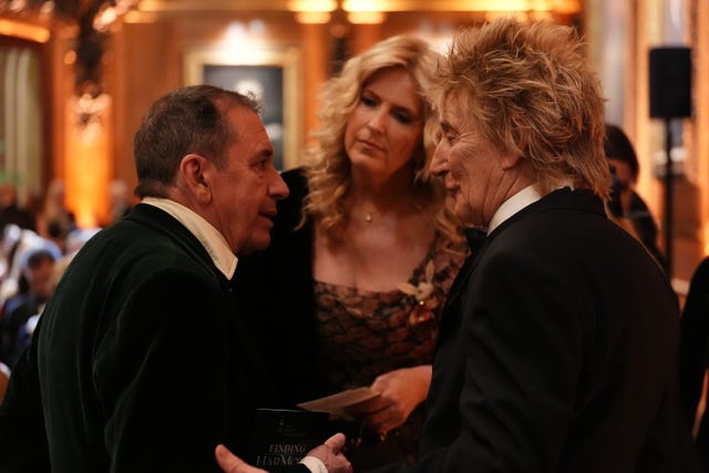Jools Holland, left, speaking to Sir Rod Stewart, right and Penny Lancaster, centre