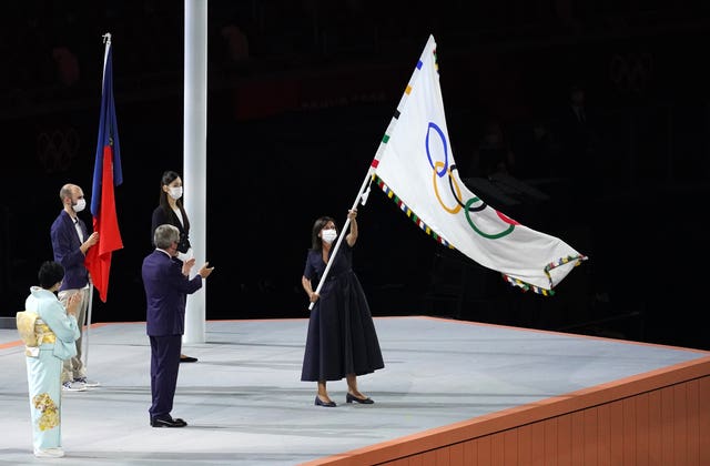 The Mayor of Paris, Anne Hidalgo, takes the Olympic flag