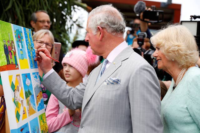 The Prince of Wales puts his painting skills to the test (Phil Noble/PA)