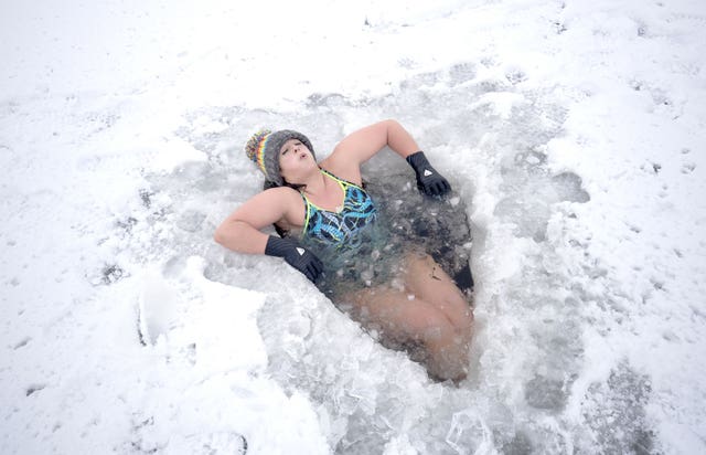 Alice Goodridge plunges through a hole in the ice in Loch Insh 