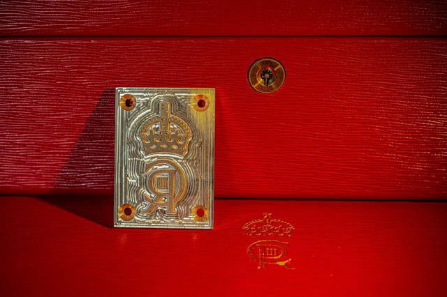 The brass engraved die which has been created to emboss the King’s cypher on to the famous red despatch boxes