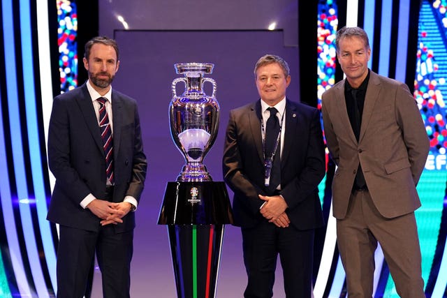 Gareth Southgate, left, with Serbia head coach Dragan Stojkovic and Denmark head coach Kasper Hjulmand, right, and the European Championship trophy at Saturday's draw