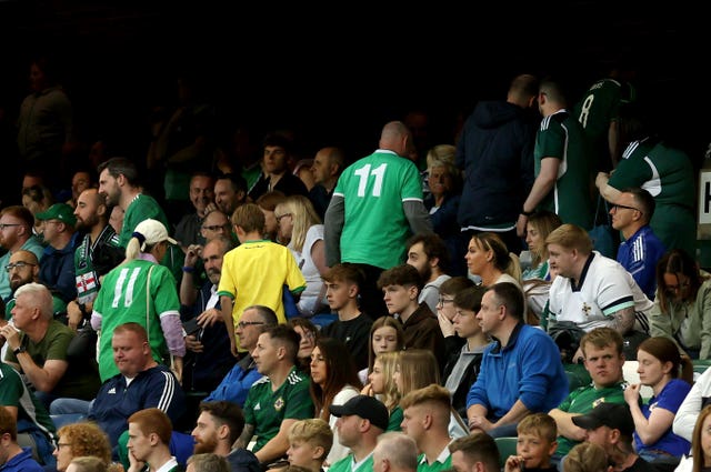 Northern Ireland fans leave the Windsor Park stands before the final whistle