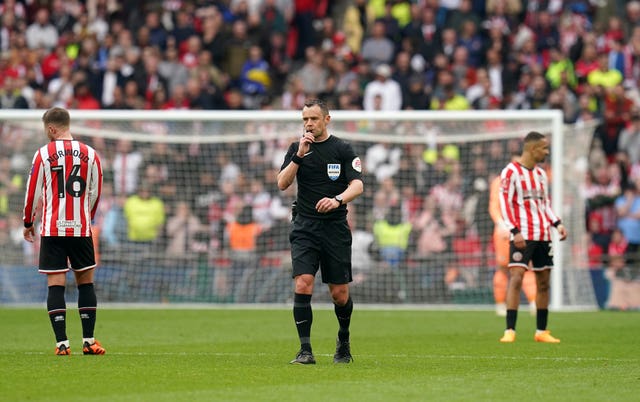 Referee Stuart Attwell blows the whistle at full-time during the FA Cup semi-final