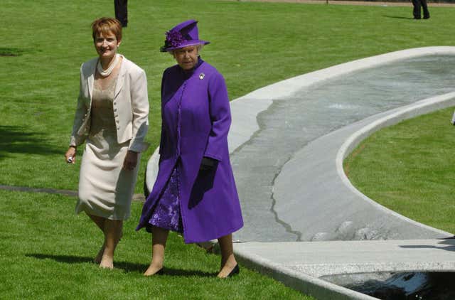 Queen Elizabeth II and Culture and Media Secretary Tessa Jowell cross a small bridge over Hyde Park Diana memorial fountain, London as it’s opening in memory of Diana, Princess of Wales (PA)