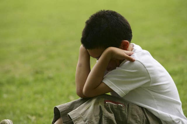 Undated handout file photo issued by the NSPCC of a young boy in distress 