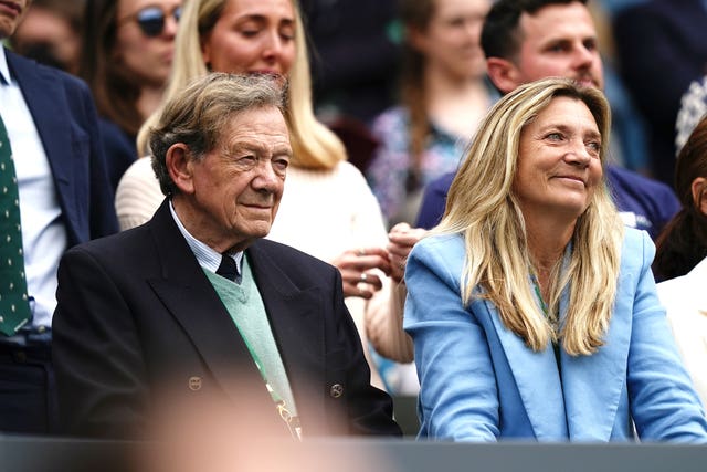 Katie Boulter's grandfather (left) and mother were in the stands for her match 