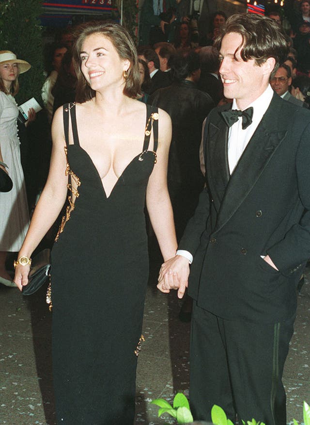 Hugh Grant arriving with actress Elizabeth Hurley for the charity premiere of Four Weddings And A Funeral 