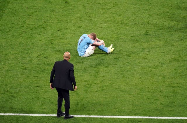 Kevin De Bruyne sits injured on the pitch before being substituted